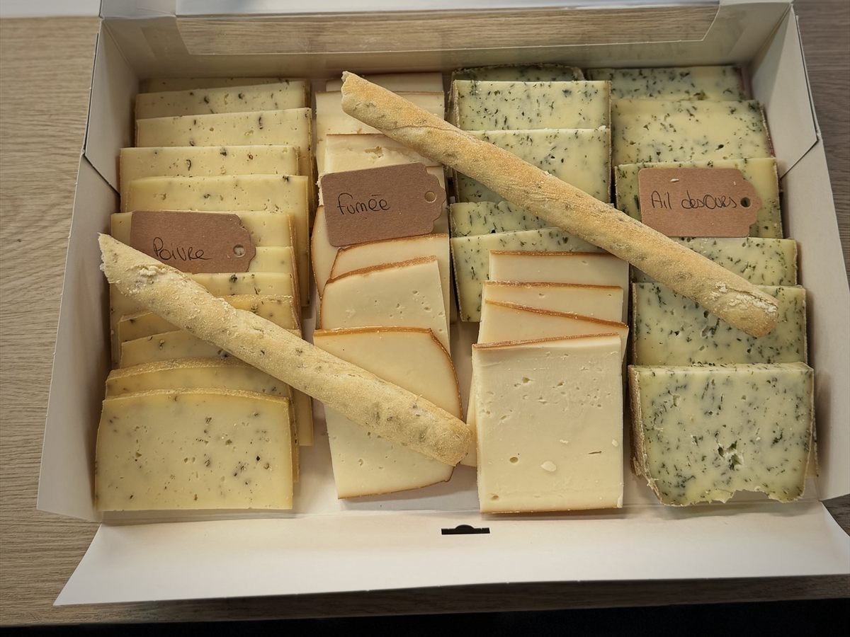 Plateau raclette en boîte : tranches classées par parfum (poivre, fumée, ail des ours) et gressins